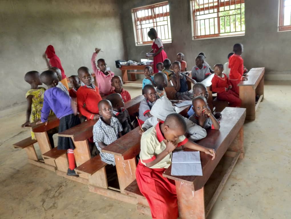 Children in class studying at desks YAVINS Education Centre Uganda