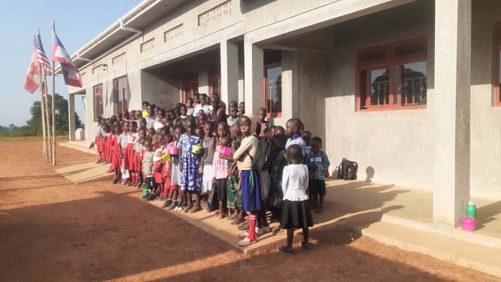 Students assembled outside YAVINS Education Centre building.