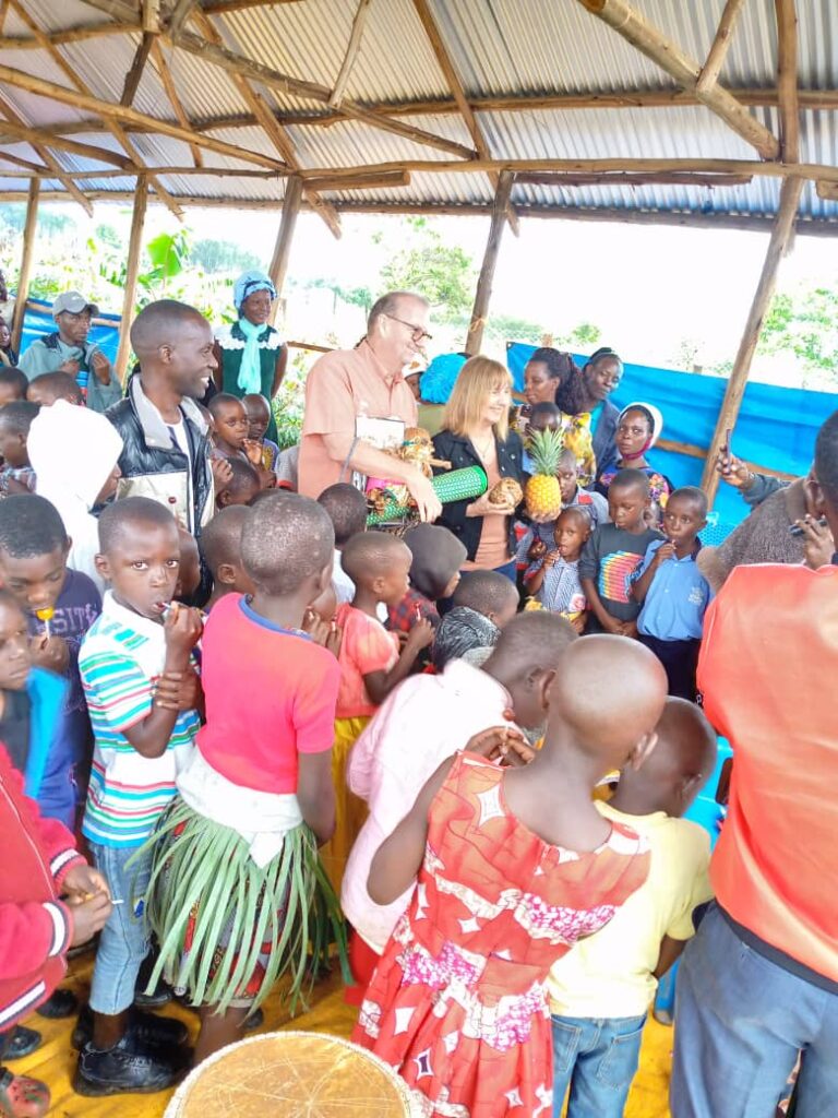 Students gathered around volunteer to listen Uganda